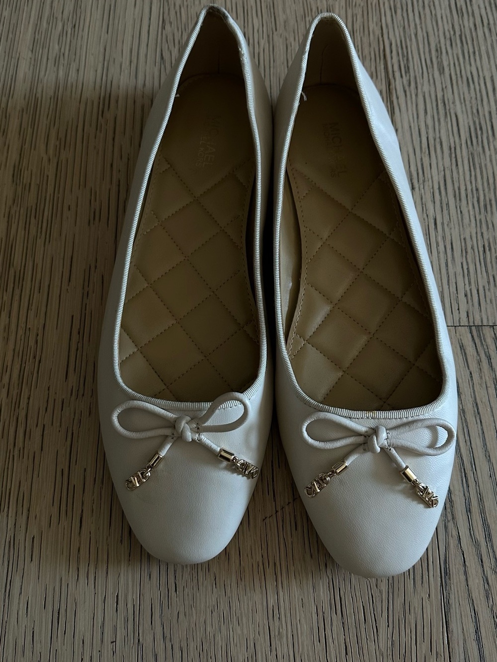 MICHAEL Michael Kors Cream Ballet Flats with Bow & Gold Accents